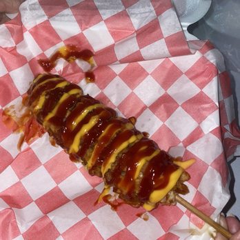 Crispy Streets - Corndog covered with breading fried and topped with ketchup and mustard. - Food Trucks Near Me - Miami, Florida