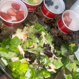 ows a salad in a plastic container