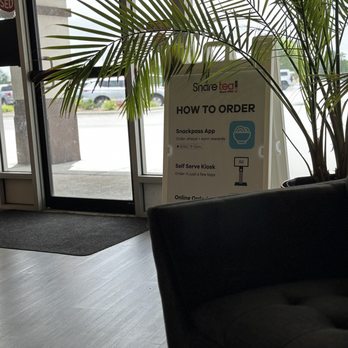 Sharetea - A sign with ordering instructions for a snack shop is placed near the entrance, with details about app ordering, self-serve kiosk, and online options. - Bubble Tea Near Me - Aurora, Illinois