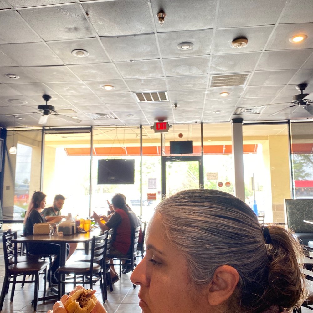 PT Pho & Tea - a woman eating a hot dog - Vietnamese Near Me - Houston, Texas PT Pho & Tea - a woman eating a hot dog - Vietnamese Near Me - Houston, Texas