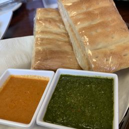 Green sauce (Chatni) and a spicy sauce that pairs well with the Potato Bolani... and everything else lol Green sauce (Chatni) and a spicy sauce that pairs well with the Potato Bolani... and everything else lol
