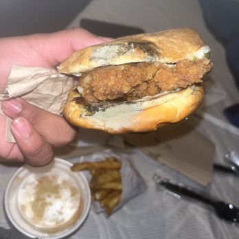 Popeyes Louisiana Kitchen - a hand holding a fried chicken sandwich - Fast Food Near Me - Taylor, Michigan Popeyes Louisiana Kitchen - a hand holding a fried chicken sandwich - Fast Food Near Me - Taylor, Michigan