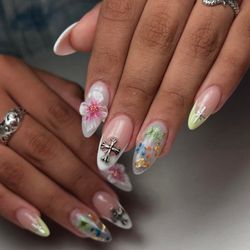 Fong's Nail Studio - Intricate designs on clear nails, featuring painted flowers and 3D embellishments for creative flair.