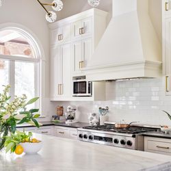 Lake Austin kitchen with cabinets painted in Sherwin Williams "Greek Villa", walls in "Neutral Ground"