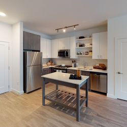 Modera Framingham by Mill Creek Residential - Stunning kitchens with gas cooking, island with storage and stainless steel appliances.