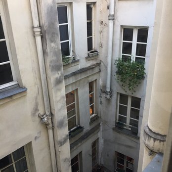 Hôtel Esméralda - My courtyard view (just add chirps) - Hotels Near Me - Paris, 75 Hôtel Esméralda - My courtyard view (just add chirps) - Hotels Near Me - Paris, 75
