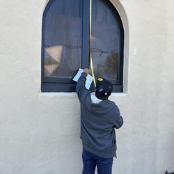All Glass - Mr Long measuring church windows with less than a week repaired.