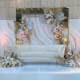 a white couch with flowers and candles a white couch with flowers and candles