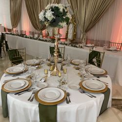 Elegant Events By Andrea - Our rentals included throne chairs, Chiavari chairs, dinnerware, centerpieces, backdrop and uplighting.