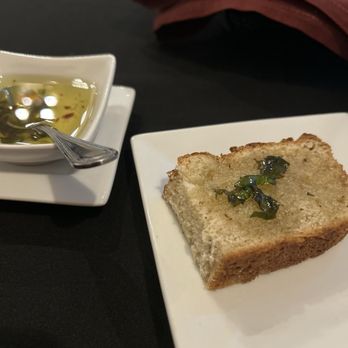 Vetro 1925 - Complimentary (I think!) soft bread with a garlic oil sauce with basil and red peppers. Very good. - Italian Near Me - Fayetteville, Arkansas Vetro 1925 - Complimentary (I think!) soft bread with a garlic oil sauce with basil and red peppers. Very good. - Italian Near Me - Fayetteville, Arkansas