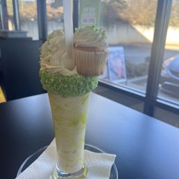 Key lime milkshake topped with a scrumptious cupcake