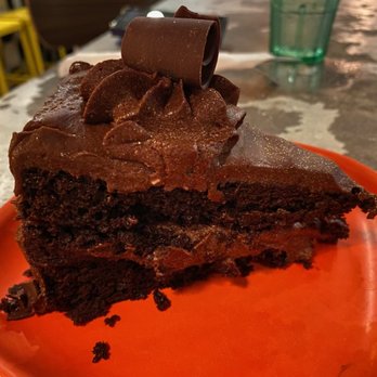 Moondog Cafe & Bakery - Chocolate cake $9.50 pretty good. Would be better if sliced as needed, but its a generous size so we cut the edge off, the middle is moist - Cafes Near Me - Key West, Florida Moondog Cafe & Bakery - Chocolate cake $9.50 pretty good. Would be better if sliced as needed, but its a generous size so we cut the edge off, the middle is moist - Cafes Near Me - Key West, Florida