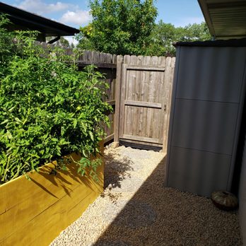 Emerald Bloom Landscaping - a yellow planter in a back yard - Landscaping Near Me - Mokena, Illinois