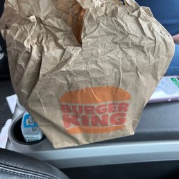 a brown paper bag on the seat of a car