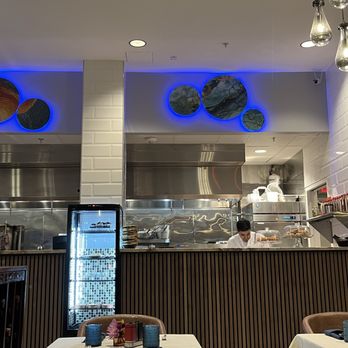 Cafe Zevian - Set tables, dessert fridge, and cooking area. - Turkish Near Me - Falls Church, Virginia Cafe Zevian - Set tables, dessert fridge, and cooking area. - Turkish Near Me - Falls Church, Virginia