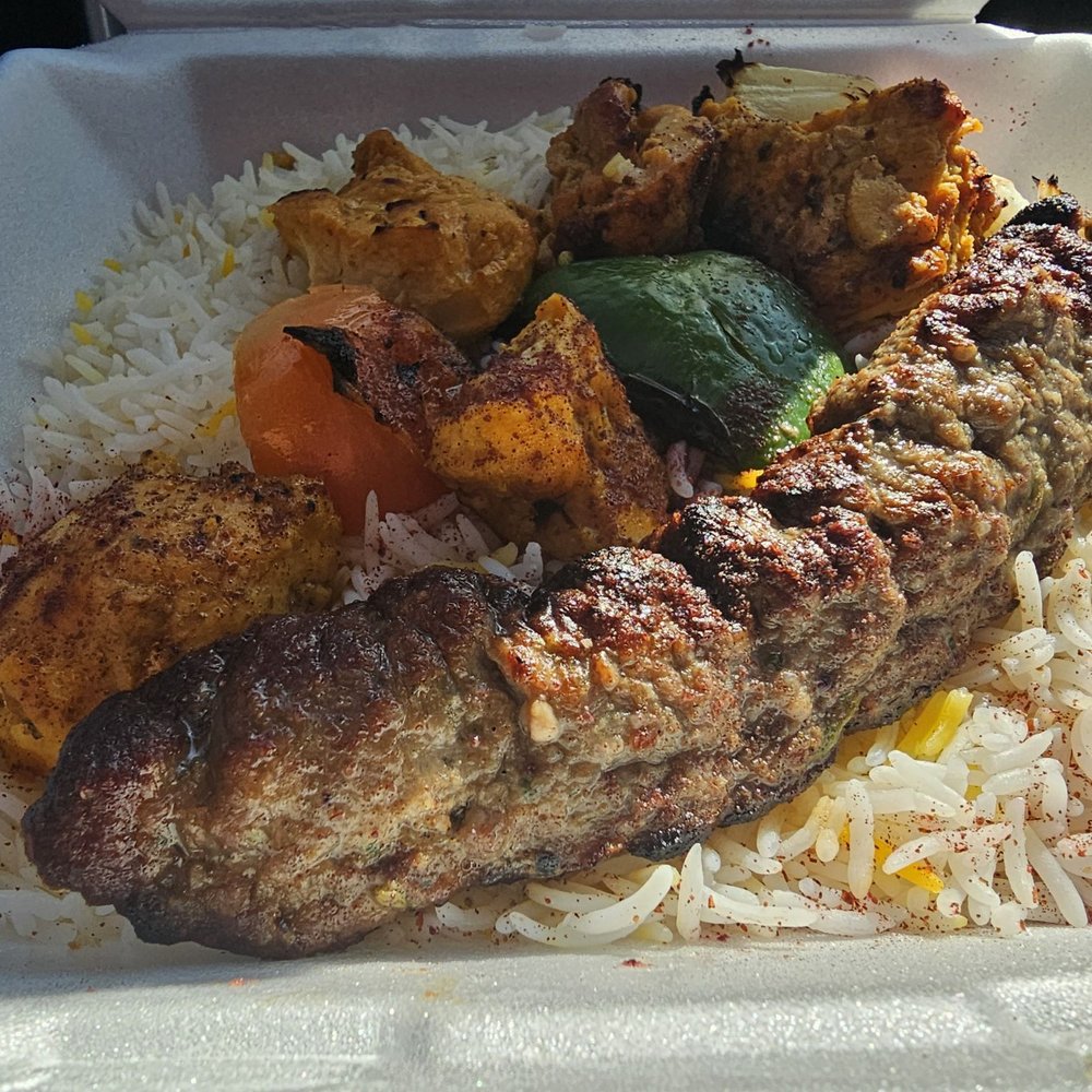 grilled meat and rice in a styrofoam container