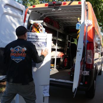 Prime Plumbing Experts - unloading the new water heater from prime plumbing experts work van - Plumbing Near Me