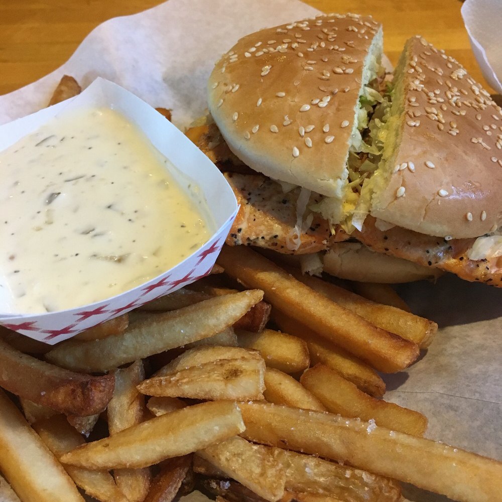 Pepperdock Restaurant - Salmon burger with a whole thick filet of salmon that was moist and not overcooked. Look at all that free tartar sauce - Fish & Chips Near Me - Seattle, Washington