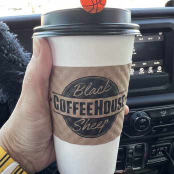 Black Sheep Coffee House - a hand holding a coffee cup - Coffee & Tea Near Me - Springfield, Nebraska