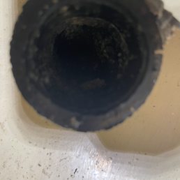 Pipe in wall clogged with sludge. Pipe in wall clogged with sludge.
