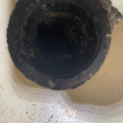 All in a Day Plumbing - Pipe in wall clogged with sludge.