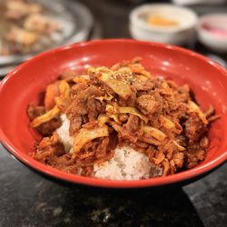 Spicy Pork Bulgogi Plate: a lot of rice and little pork with some onions and cabbage.