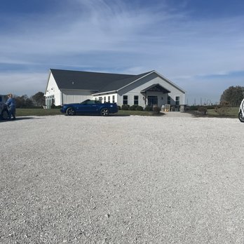 The Pour Vineyard - a white barn and a blue car - Wineries Near Me - Red Bud, Illinois