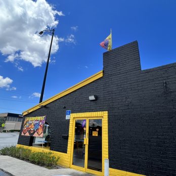 La Salchipaperia D.C. -  a black building with yellow trim - Burgers Near Me - Oakland Park, Florida