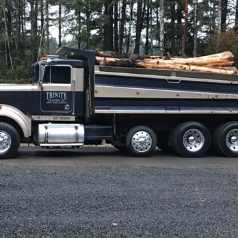 Trinity Excavating - a truck with logs on the back - General Contractors Near Me - Port Orchard, Washington Trinity Excavating - a truck with logs on the back - General Contractors Near Me - Port Orchard, Washington