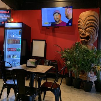 Matiki Island Barbecue - Drinks, TV, table, tiki statue and plants - Hawaiian Near Me - Fullerton, California Matiki Island Barbecue - Drinks, TV, table, tiki statue and plants - Hawaiian Near Me - Fullerton, California