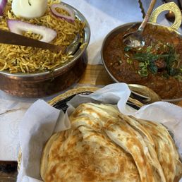 Delicious parotta, goat biryani and chicken curry Delicious parotta, goat biryani and chicken curry