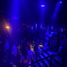 a crowd of people in a dark room a crowd of people in a dark room