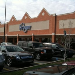 cars parked in front of a kroger store