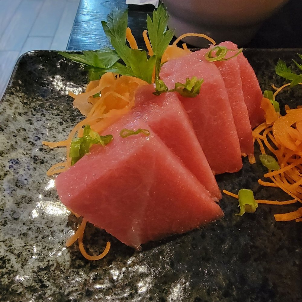 Kiyomi Sushi - three pieces of watermelon on a black plate - Sushi Bars Near Me - Bel Air, Maryland Kiyomi Sushi - three pieces of watermelon on a black plate - Sushi Bars Near Me - Bel Air, Maryland