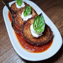 Kitchen76 - Eggplant rounds in panko bread crumbs with pasta sauce and a dollop of cream fresh with a basil accent. Yummy.