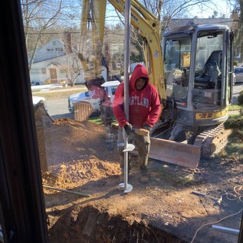 Levelift Foundations - Giovanni holding a helical pile prior to install. - Structural Engineers Near Me - Ellicott City, Maryland