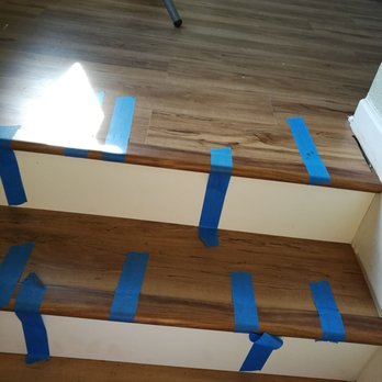 Wall 2 Wall Construction - Gaps between installed vinyl and baseboards; unremoved work tape - General Contractors Near Me