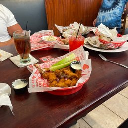 two people sitting at a table with plates of food