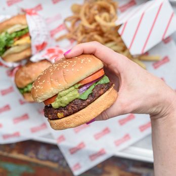 Tasty Burger - a hand holding a hamburger - Burgers Near Me - Cambridge, Massachusetts Tasty Burger - a hand holding a hamburger - Burgers Near Me - Cambridge, Massachusetts