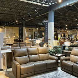 Carter's Furniture - Flexsteel Gallery at the Carter's Furniture Showroom in Urbana, IL featuring a leather reclining sofa and loveseat and Flexsteel signage.