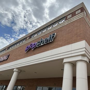 pOpshelf - Exterior view of pOpshelf store in Plano, TX, showing its brick facade, white columns, and signage against a cloudy sky. - Party Supplies Near Me - Plano, Texas