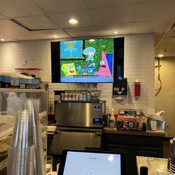 Cafe Lucia - a large flat screen tv in a restaurant - Coffee & Tea Near Me - Atlanta, Georgia