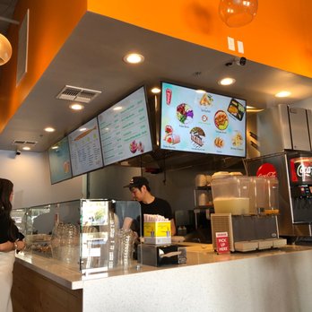 Lomi Poki - a woman ordering food at a restaurant - Poke Near Me - Tempe, Arizona