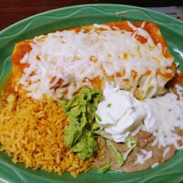 a plate of enchiladas and rice a plate of enchiladas and rice