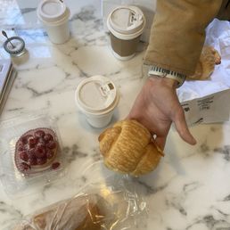 Raspberry tart, egg sandwich, turkey croissant, coffee