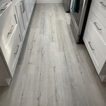 Floor 2 you - a kitchen with white cabinets and wood floors - Flooring Near Me - Boca Raton, Florida Floor 2 you - a kitchen with white cabinets and wood floors - Flooring Near Me - Boca Raton, Florida