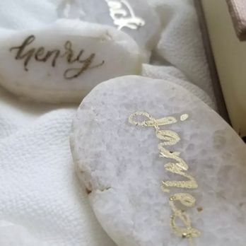 Kim Kalligraphy - Names written on rocks as placeholders. instagram.com/kimkalligraphy - Calligraphy Near Me