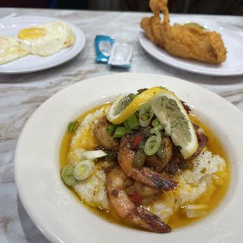 Elicious - Shrimp and grits, catfish fillet, and over medium eggs. - Southern Near Me - Ferguson, Missouri