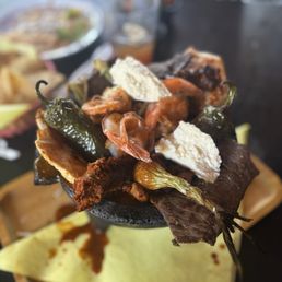 Molcajete with asada, pollo asado, shrimp, chorizo, jalepenos.