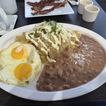 Orale Guey - My breakfast green chilequiles, sunny side up eggs and wonderful beans - Mexican Near Me - Columbus, Ohio